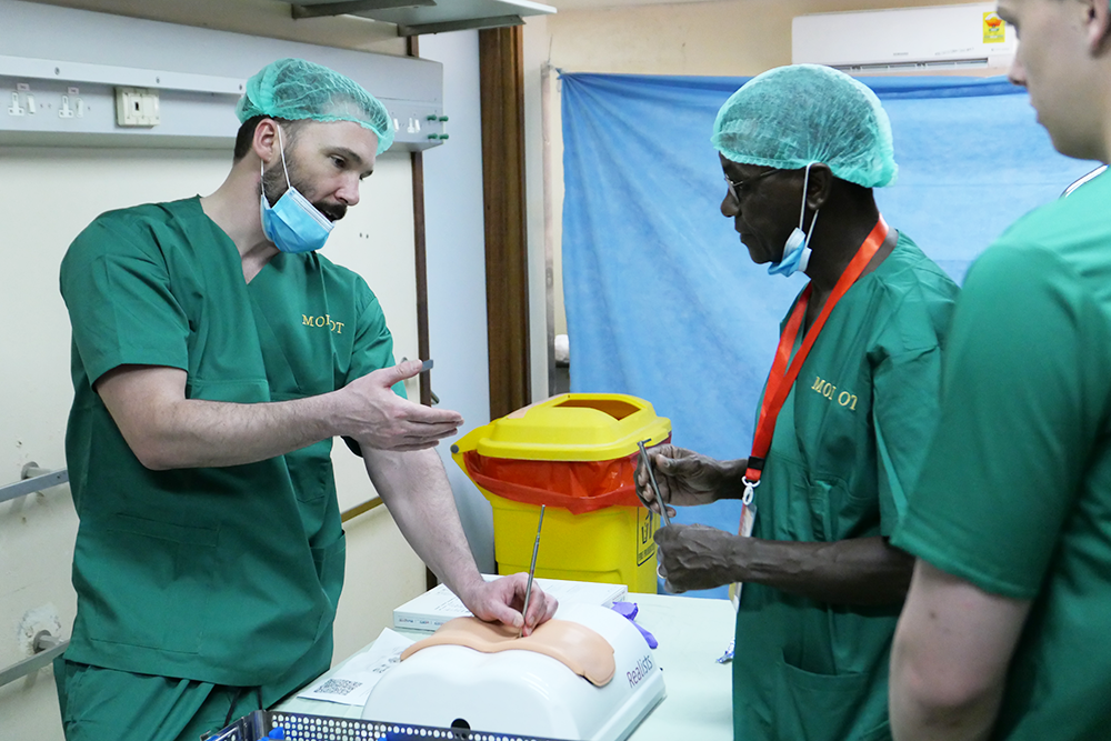 Dr. Lynn McGrath teaches Tanzanian doctors on a spine surgical training model