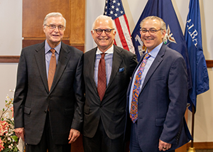A. John Popp, MD, Professor Emeritus of the Department of Neurosurgery at Albany Medical College, and Alan Boulos, Dean of the Medical College, flank Dr. Philip Stieg at the ceremony that named him Distinguished Alumnus for 2022.