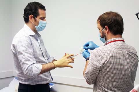 Dr. Michael Kaplitt and RN Jason Randazza prepare the local anesthetic to number the patient's scalp